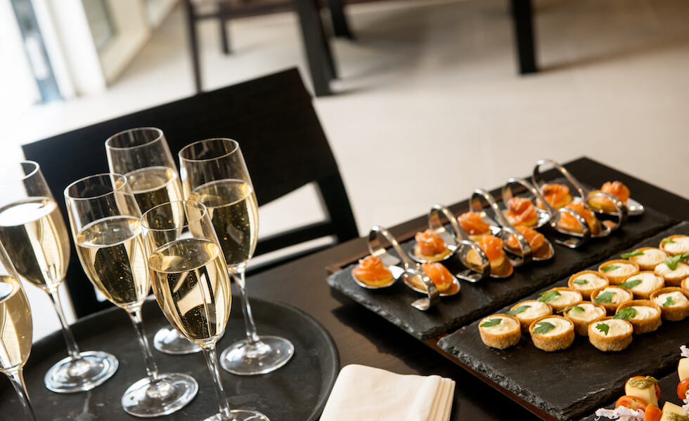 Champagne And Appetizers On A Black Table